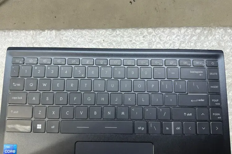 The image displays a laptop keyboard after repair. All the keys are now in place, with no missing components visible. The keyboard looks clean and well-maintained, with each keycap showing clear and legible lettering. 